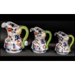 Three Rington's Tea Merchants Jugs, hand painted with blue and gilt floral decoration with green