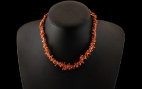 Pink Coral Necklace. Early 20th century coral necklace in natural form, gold coloured clasp, 16'' in