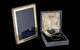 A Small Silver Modern Photo Frame together with a child's boxed pusher and spoon.