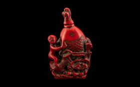 Chinese Resin Perfume Bottle, well carved, depicting a man holding up a large fish; good detail