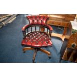 A Ox Wood Leather Captains Chair foot, backrest and seat of typical form. Legs are slightly loose.