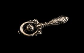 Early 20th Century Silver Rattle, the handle decorated with cherubs; fully hallmarked