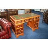 A Modern Traditional Ewe Wood Pedestal Desk of typical form. Green leather top, three frieze