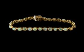 Natural Opal Tennis Bracelet, a wonderful array of colours showing in a single row of oval cut,