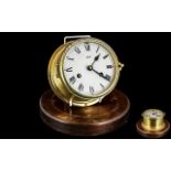 Original Brass Ships Clock, wind-up clock on wooden base, lacking glass; 7 inches (17.5cms) in