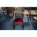 An Antique Profusely Carved Burmese Stand Chair, on shaped cabriole legs and a shaped round back,