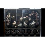 A Six Panel Chinese Lacquered and Harstone Applied Screen depicting wild horses in landscape with