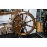 A Extra Large Teak Antique Ship Wheel with brass mounts of typical form. Diameter 53 inches.