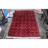 A Genuine Excellent Quality Persian Turkmen Carpet/Rug decorated in a Bukhari design on red ground.