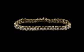 A 9ct Gold - Diamond Set Kisses Design Bracelet In Two Tone Gold Set with Diamond Chips. Fully