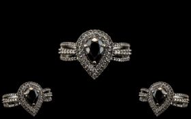 Ladies 14ct White Gold Pear Shaped Black and White Diamond Set Dress Ring. The Central Pear Shaped