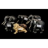 Group of Seven Ebony Elephants with tusks, plus a pottery lion figure (8)