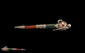 An Unmarked Scottish Silver Hardstone Brooch in the form of a Scottish Dirk. One stone cracked.