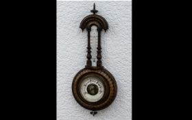 Small Carved Walnut Wall Barometer and thermometer, with a carved surround and column decoration.