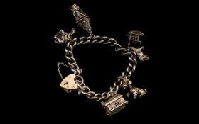 Substantial Silver Charm Bracelet with some good examples amongst the quantity of charms; 54 grams