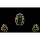 Large Malachite Ring, an elongated oval, cabochon cut malachite, of rich green with typical