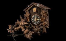 Vintage Carved Wood Cuckoo Clock with bird and leaf decoration to pitched top, and leaf and nest