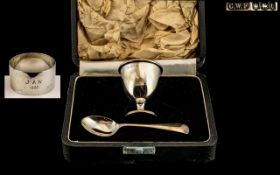 A Silver Christening Set to include an egg cup, spoon and associated napkin ring.