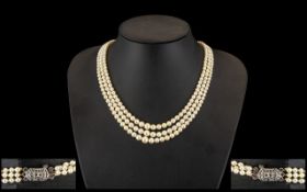 Attractive Triple Strand, Graduated Cultured Pearl Necklace, with excellent colour and lustre,