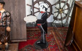 Mid Century Dumb Waiter Shop Display. Shop display dumb waiter, gentleman in tail and swags, holding