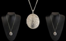 Large Silver Locket Suspended on a Silver Necklace,