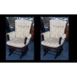 A Pair of Upholstered Stained Mahogany Cottage Rocking Chairs made by Dutailier,