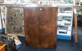 A Mid Century Bow Fronted Walnut Finish Cocktail Cabinet.