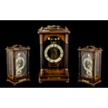 A Modern Skeleton Clock with Franz Hermle with a mahogany finish glass case with brass carrying
