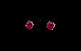 Ruby Stud Earrings, each a round cut solitaire ruby of good colour,