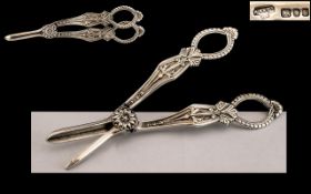 Elizabeth II Ornate Pair of Sterling Silver Grape Scissors with Highly Embossed Ornate Decoration.