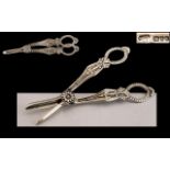 Elizabeth II Ornate Pair of Sterling Silver Grape Scissors with Highly Embossed Ornate Decoration.