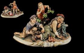 Large Capodimonte Porcelain Figure by Rori of Tramp Sleeping, with two children. 14.5” wide.