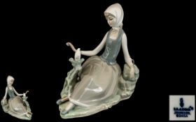 Lladro Figure 'Girl with Bird' marked to base, in excellent condition. Measures 7" long x 7" tall.