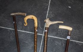 A Collection of Four Walking Canes one with a horn handle,