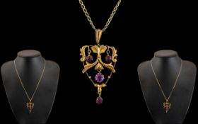 Edwardian Period 9ct Gold Openwork Pendant set with amethysts of attractive appearance,