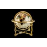 World Map Gem Globe on a brass gimbel, decorated with mother of pearl. Height 14".