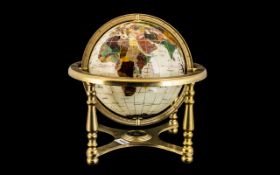 World Map Gem Globe on a brass gimbel, decorated with mother of pearl. Height 14".