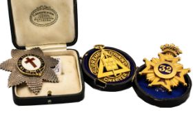 Three Masonic Breast Badges comprising 'In Hoc Signo Vinces' silver and enamel breast badge,