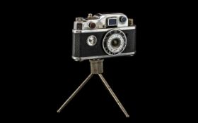 1950s Lighter In The Form Of A Camera, a desk top lighter, on tripod feet, in imitation of a vintage