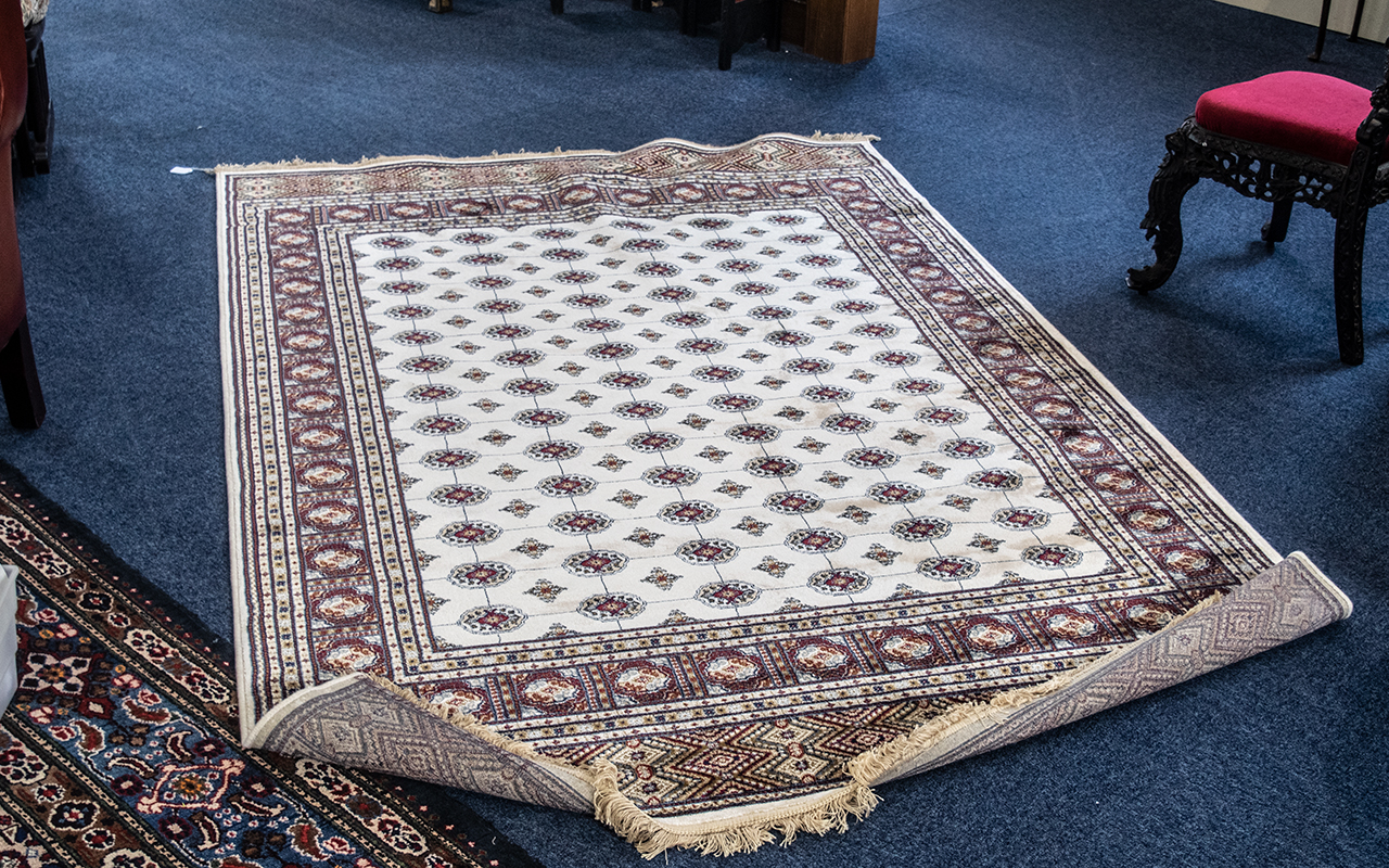 A Genuine Cashmere Rug, in as new condition, With cream ground, Measures 90 by 60 inches.