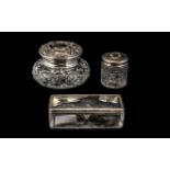 Three Silver Topped Glass Dressing Table Trinket Boxes, comprising a hair tidy,