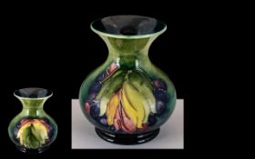 Moorcroft Tubelined Small Bulbous Vase, 'Leaves and Berries' design on a green/blue ground, c 1930s,
