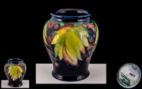 Moorcroft Tubelined Signed Ovoid Vase, 'Leaves and Fruit' design on a blue ground, 5.75 inches (16.