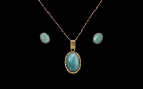 A 14ct Gold Pendant set with a turquoise coloured cabochon stone.