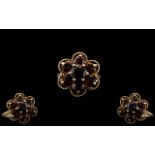 Ladies 9ct Gold Attractive Garnet Set Ring - Flower head Setting. Fully Hallmarked for 9.375.