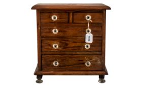 A Victorian Miniature Pitch Pine Chest of Drawers, two short over three long graduating drawers,