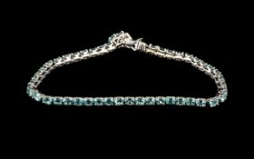Paraibe Blue Apatite Tennis Bracelet, 8cts of oval cut apatites, with the striking sea blue colour,
