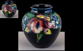 Moorcroft Small Bulbous Vase, 'Orchids' design on a blue ground, c 1930s, 4.25 inches (10.