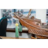 Model Boat of A Pirate Ship made out of wood and on a plinth. Chinese engravings to the rear.