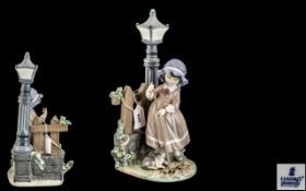 Lladro Figure of a girl sweeping by a lamp post with a kitten, measures 34 cms high.